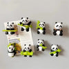 A collection of three-dimensional panda fridge magnets featuring various poses and accessories.