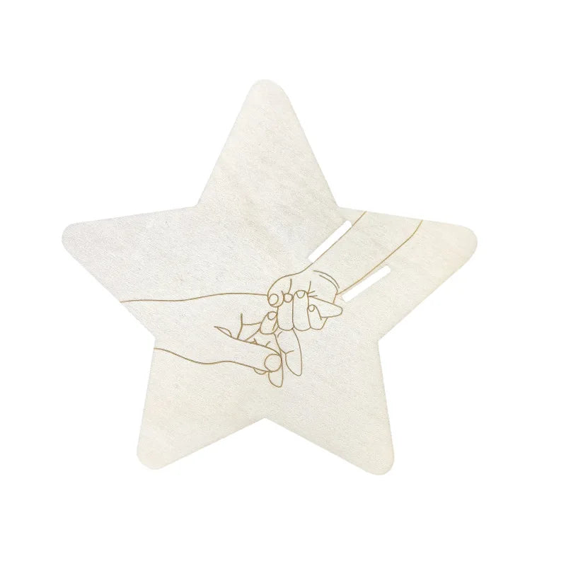 A light beige star-shaped keepsake sign with a handprint design etched into the surface.