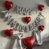Silver and red foil balloons spelling out Happy Anniversary
