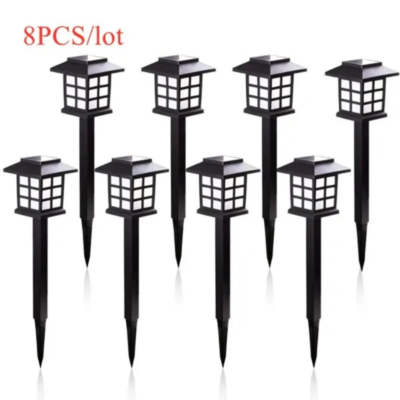 Eight black solar powered LED pathway lights with square lanterns