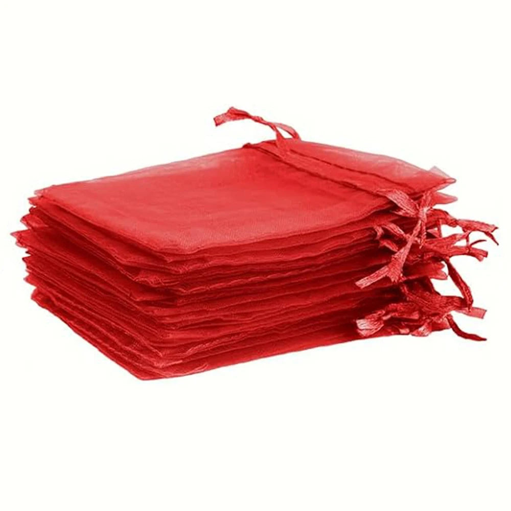 A stack of red organza drawstring bags for gifts, weddings, and parties.