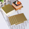 Metallic gold and silver dessert cake boards with a slice of cake and topping