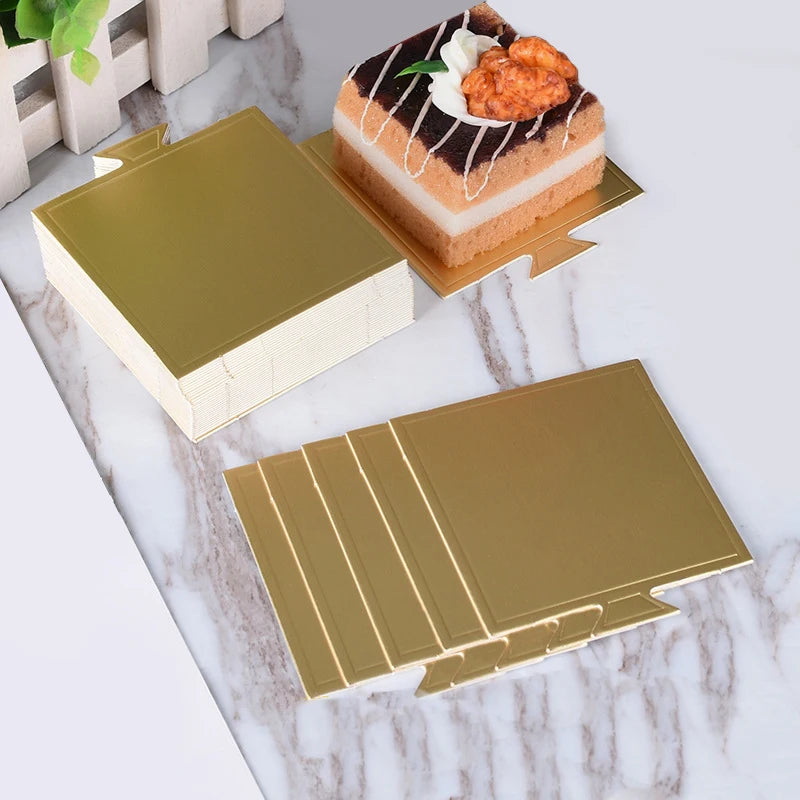 Metallic gold and silver dessert cake boards with a slice of cake and topping