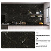A dark marble pattern self-adhesive backsplash panel installed on a kitchen wall with various accessories.