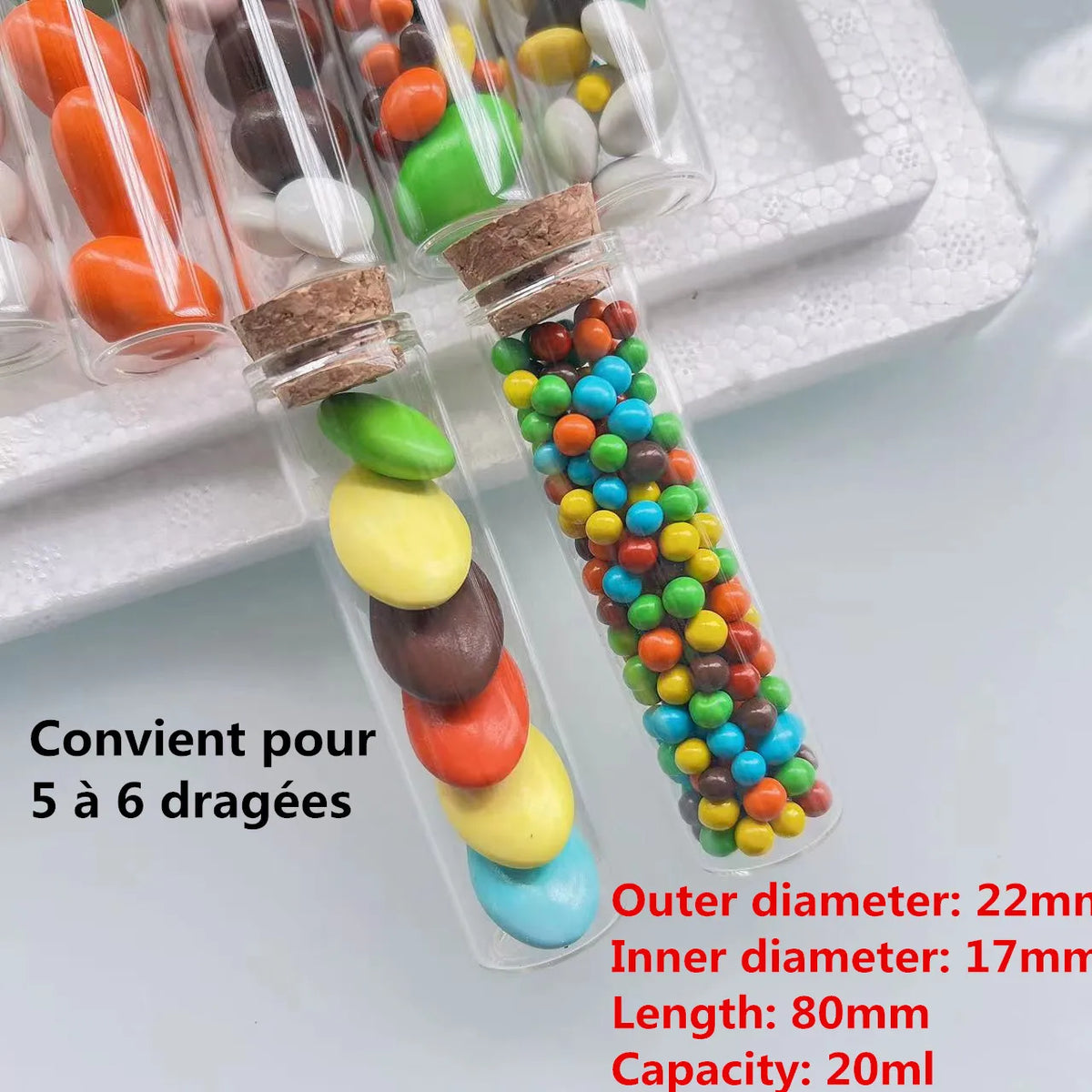 Mini glass bottles with cork stoppers filled with colorful candies for DIY crafts