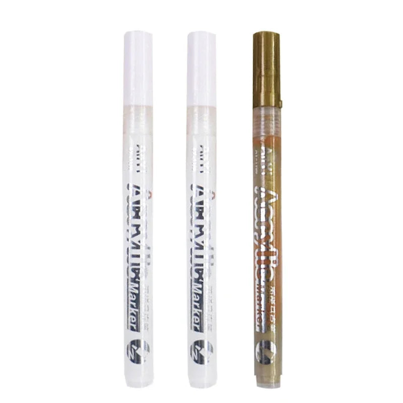 A set of Extra-Fine Point Acrylic Paint Pens for Multi-Surface Art in white and gold packaging.