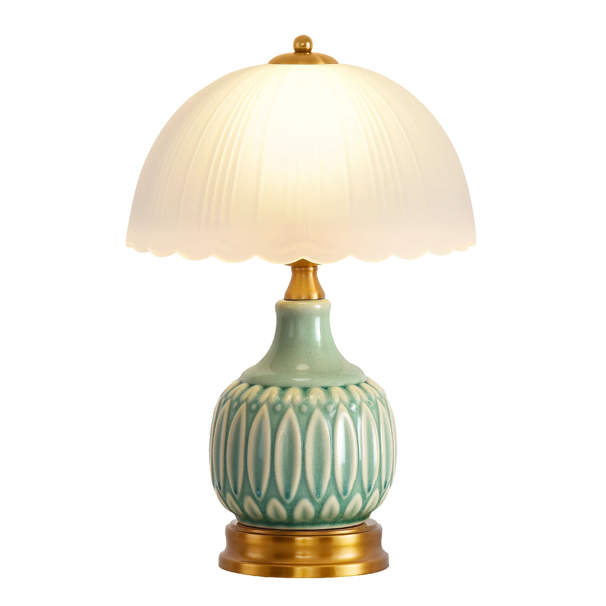 A ceramic table lamp with a pale green crackle glaze base and a white fabric shade atop a brass fitting.
