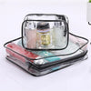 A clear waterproof toiletry bag with a black zipper containing various cosmetic bottles.
