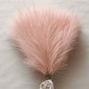 A fluffy pink artificial pampas grass bouquet used for boho home decor.