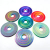 A collection of colorful, iridescent rotating ball spinners or fidget toys arranged on a white background.