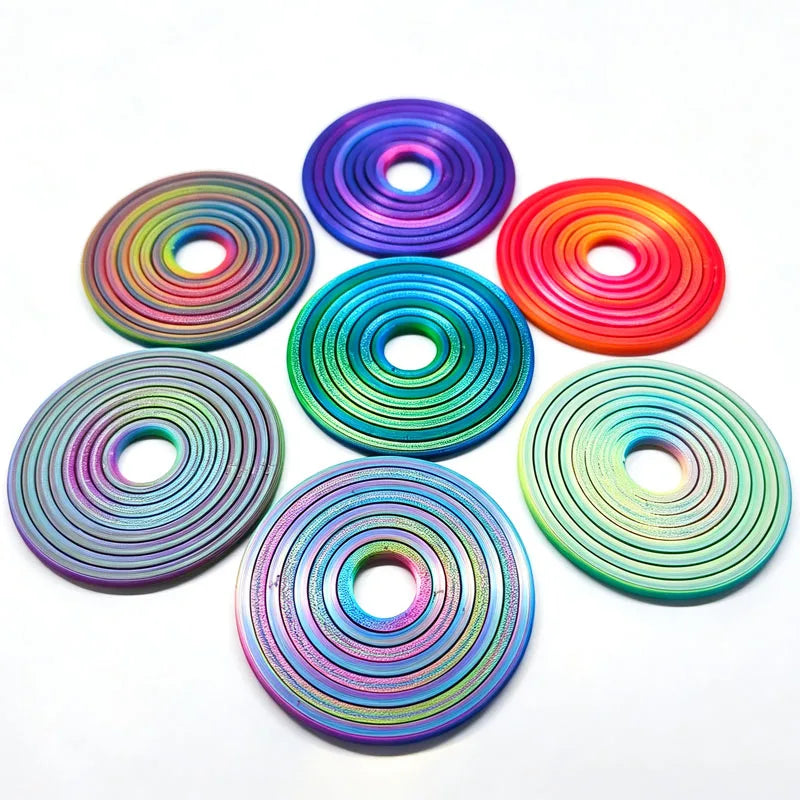 A collection of colorful, iridescent rotating ball spinners or fidget toys arranged on a white background.