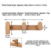 Wooden coat rack wall mount featuring a three-hook base and large and small horseshoes for entryway display