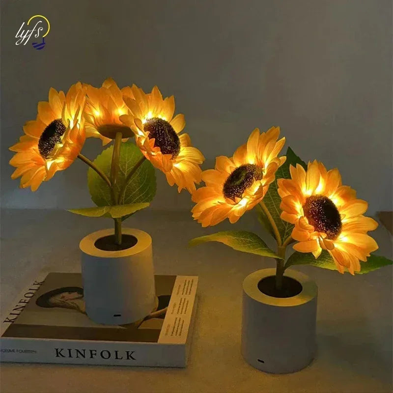 A bright yellow sunflower LED night light with a dark center is displayed in a white ceramic pot.