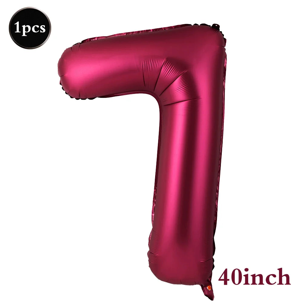 A single, large, metallic magenta foil number balloon shaped like the numeral 7.