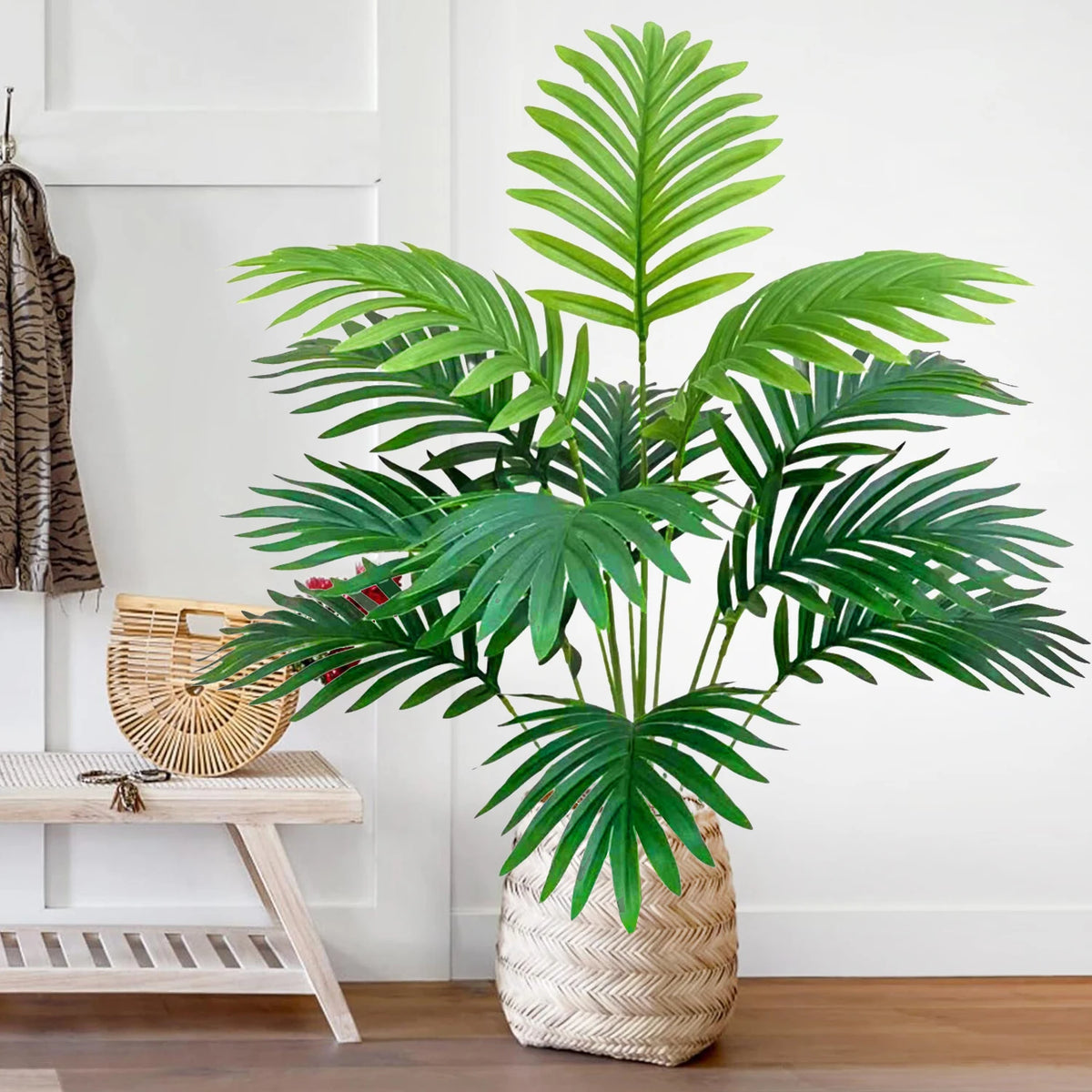 A realistic artificial palm tree with vibrant green silk leaves potted in a woven basket.