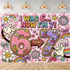 A colorful wall decal featuring text I Was 6 Now I Am 7 surrounded by rainbows, flowers, and glittery elements.