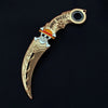A gold-colored anime-style rotating claw knife model with a dragon motif and skull detail.