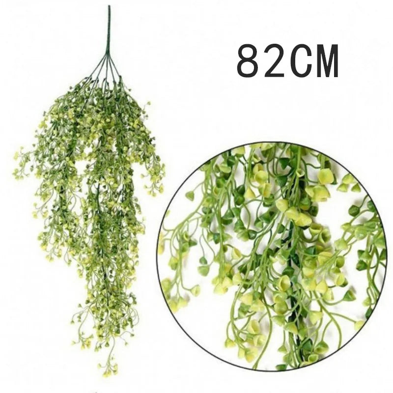 A long, cascading artificial plant vine wall hanging with small green leaves.
