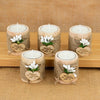 Four natural fiber candle holders with white candles and thank you message tags arranged on a wooden surface.