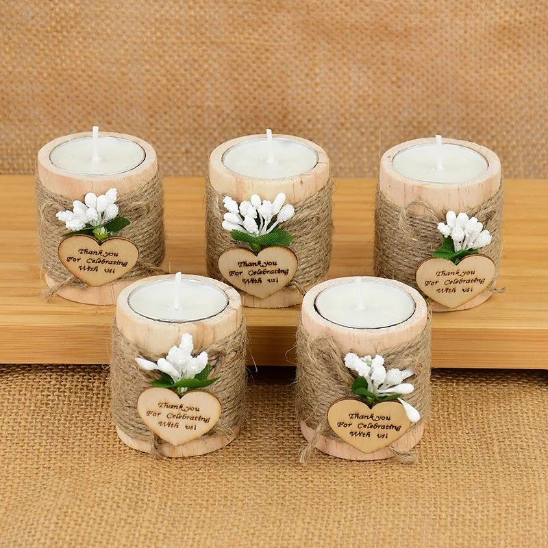 Four natural fiber candle holders with white candles and thank you message tags arranged on a wooden surface.