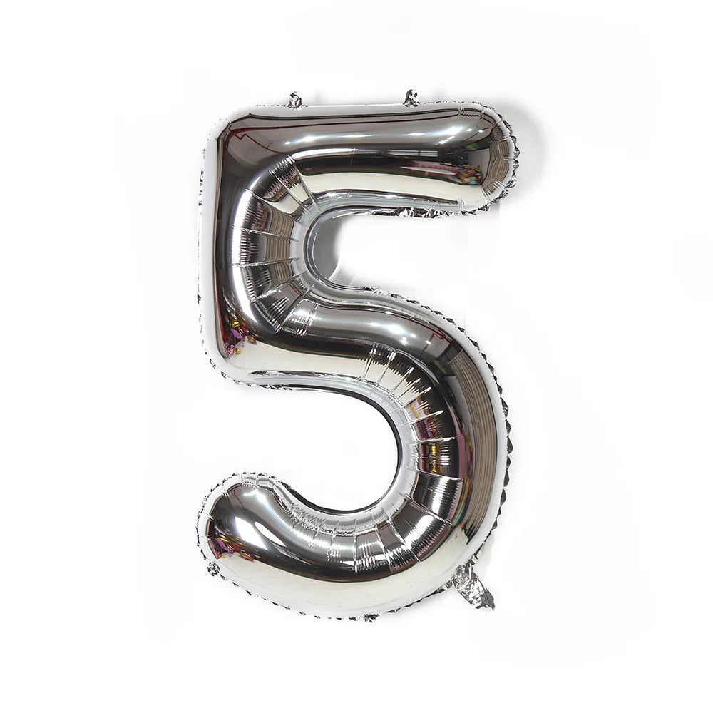 A metallic silver foil balloon shaped like the number five.