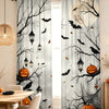 Gray curtains featuring black tree branches, bats, and pumpkins for a spooky Halloween theme