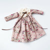Vintage lace pajama set for a doll featuring a pink floral print and a fabric bow