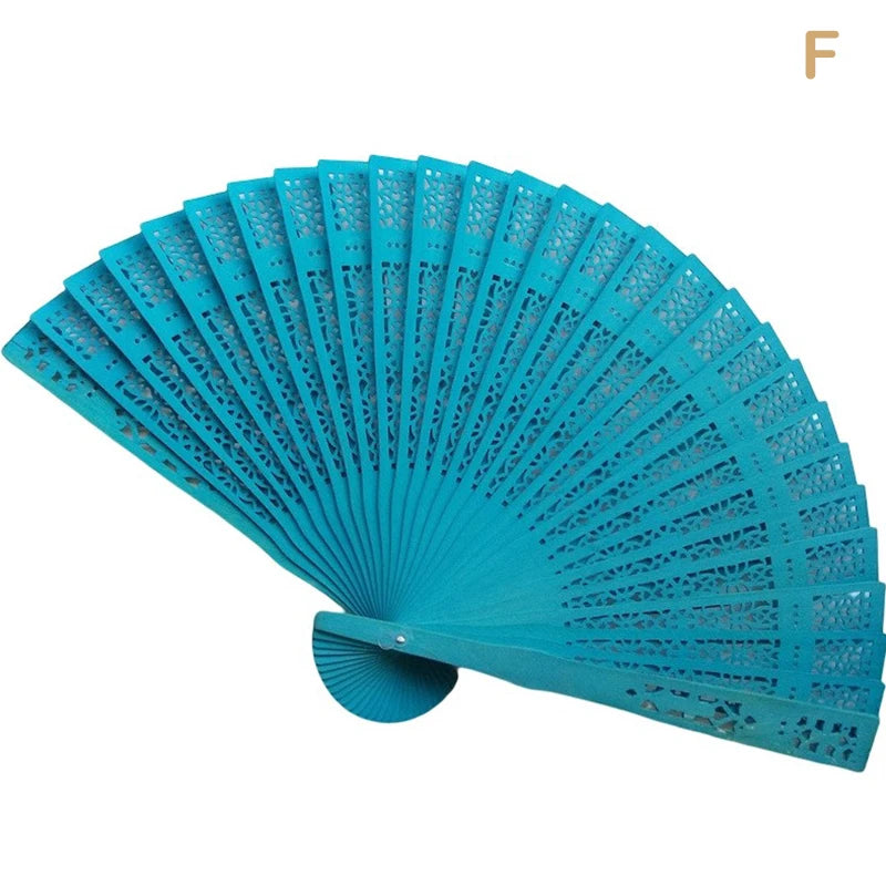 A bright turquoise hand carved bamboo folding fan shown open and angled.