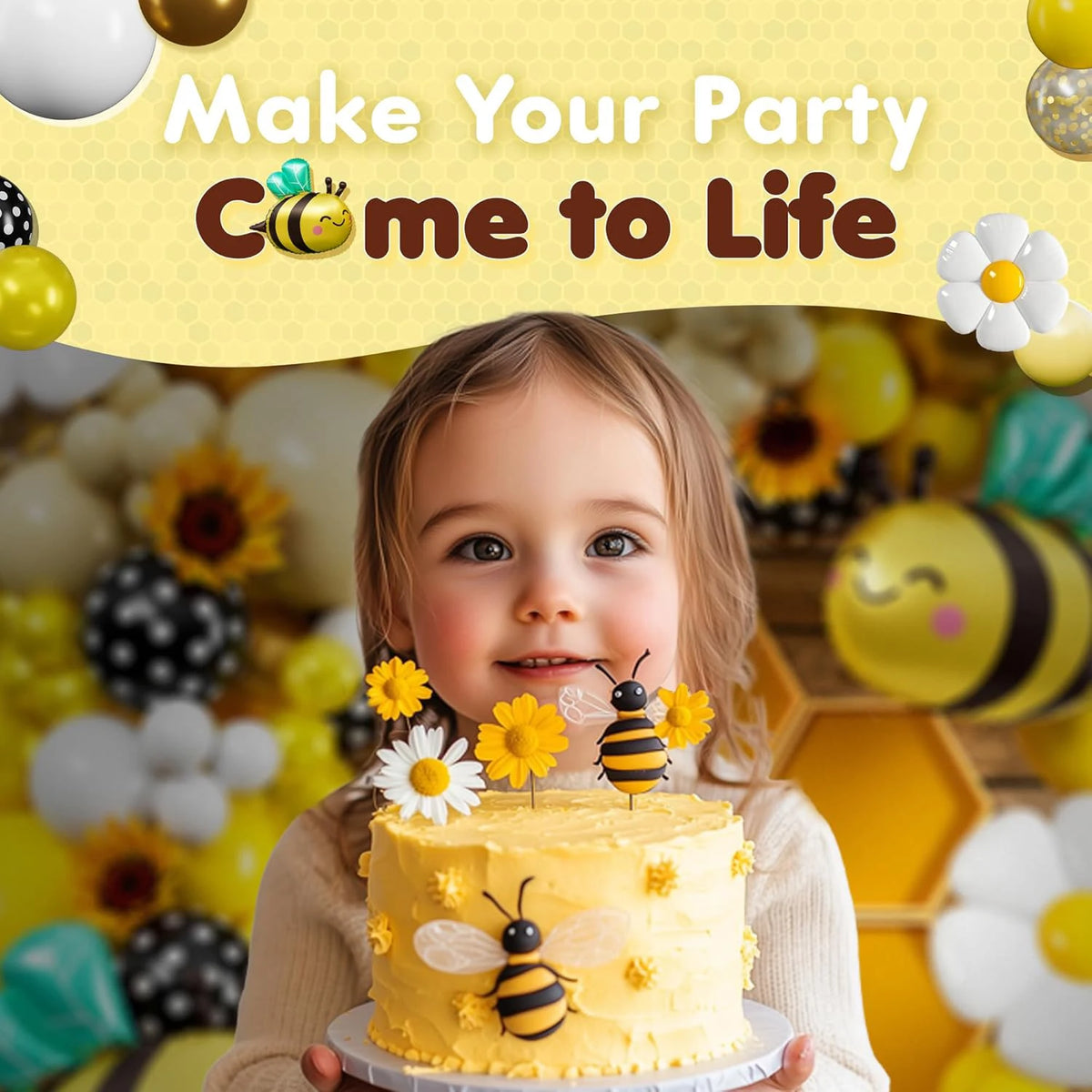 A child smiles holding a yellow cake decorated with bees and flowers, set against a background of yellow balloons.