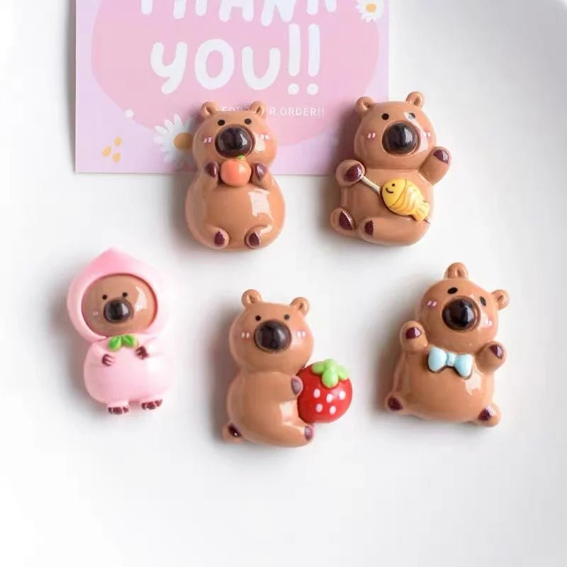 A set of adorable brown and pink guinea pig refrigerator magnets featuring various expressions and accessories.