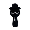 A black plush toy set resembling a man with closed eyes and a tie.