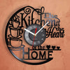 A black wall clock design featuring a vintage vinyl record theme with decorative script and a clock face.