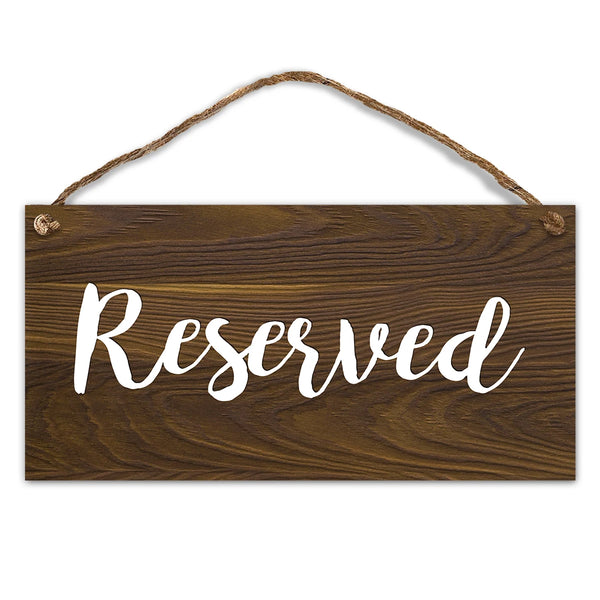A dark brown wooden sign with the word Reserved written in white script, featuring natural twine for hanging.