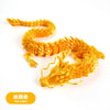 A detailed resin figurine of a golden dragon ornament with textured scales.