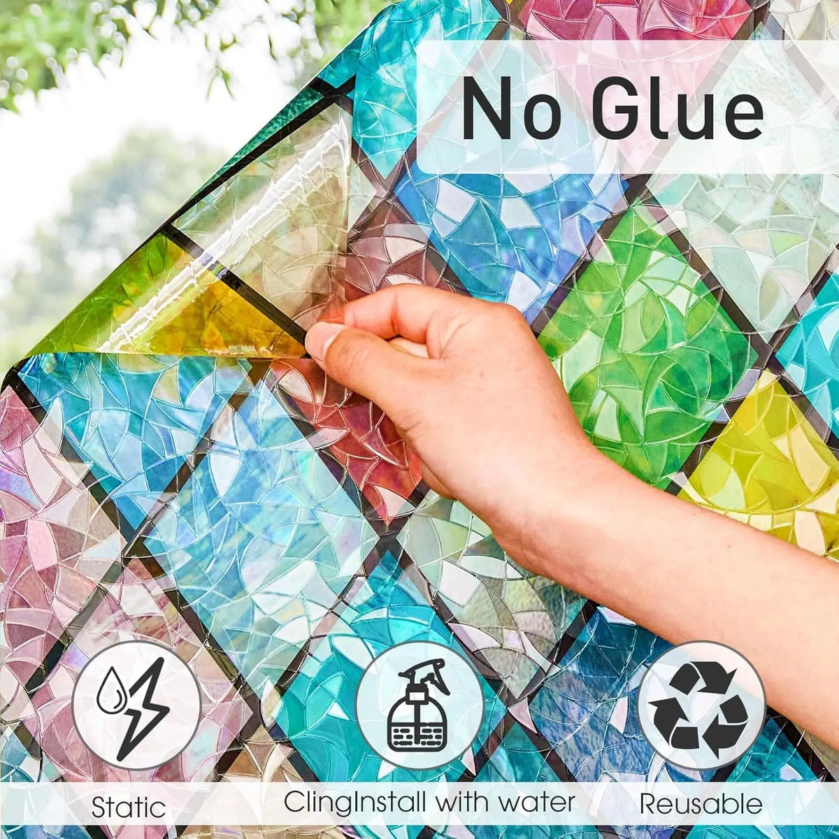 Hand applying no glue window film to a glass surface, highlighting its static cling and reusable features.