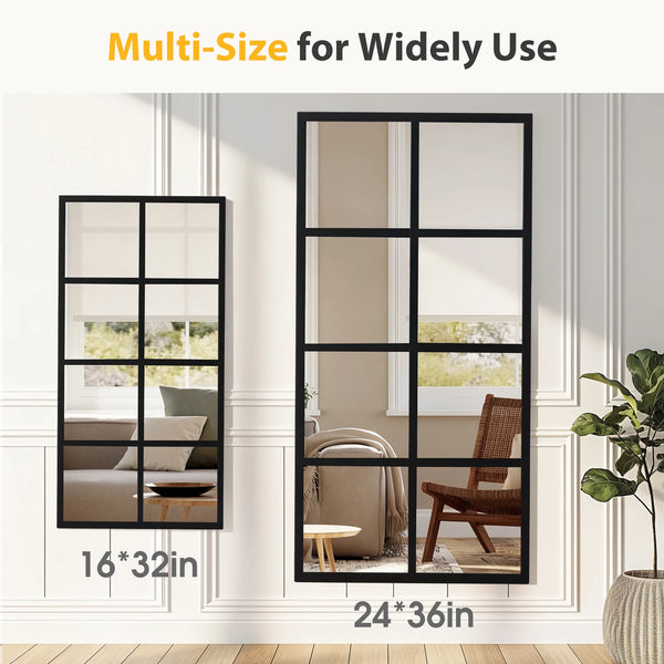 A black metal framed multi-size window pane wall mirror displayed in a white interior setting.