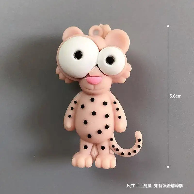 A pink cartoon animal figure with large white eyes and black spots, shown against a gray background.