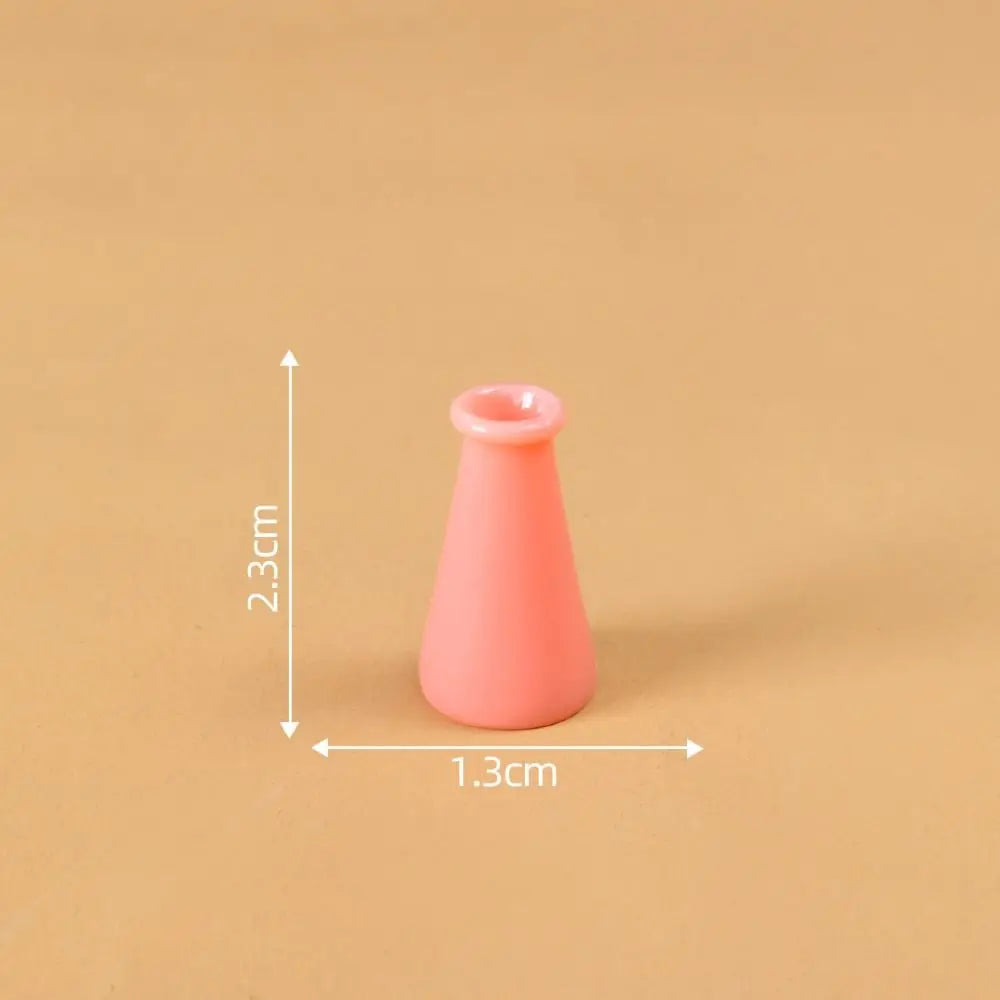 A small, pink, conical resin vase shown against a neutral background with dimension lines.