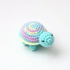 Handmade crocheted turtle plush with multicolored spiral shell and blue body