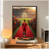 A framed poster of Cristiano Ronaldo in a red jersey standing on a green field with a red tunnel entrance.