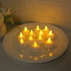 A plate holds ten glowing yellow LED floating candles casting a warm light on a white surface.