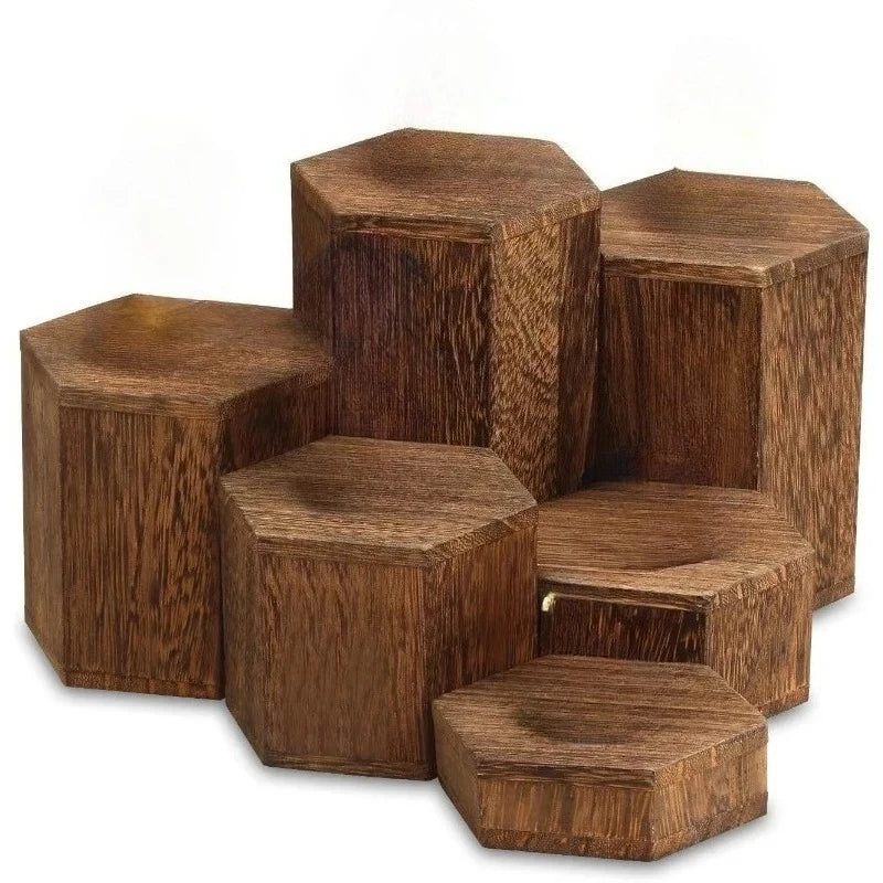 A stack of dark brown wooden hexagonal display racks for jewelry and accessories.