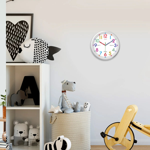 A minimalist white and black decorative wall clock with a blue face hangs on a light gray wall.
