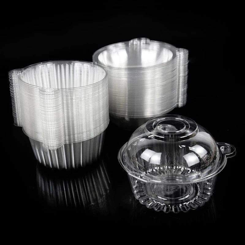 A stack of clear plastic cupcake boxes with lids, showing various sizes and a reflective surface.
