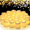 A cluster of glowing yellow LED tea light candles against a dark background with sparkling bokeh lights.