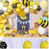 A yellow and black bee themed balloon arch wreath set decorated with honeycomb shapes and flowers.