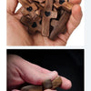 A hand holds several small wooden crosses with epoxy hearts for spiritual comfort.