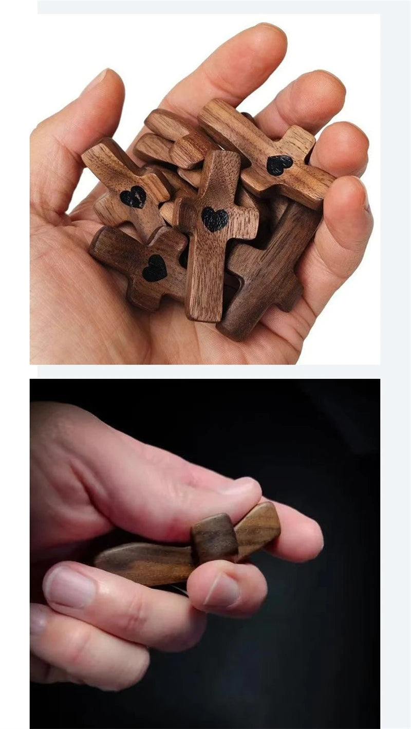 A hand holds several small wooden crosses with epoxy hearts for spiritual comfort.