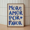 A framed canvas print featuring the text MORE AMOR POR FAVOR written in blue script on light beige paper.