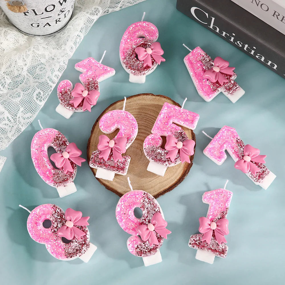 Pink sequin bow decorative birthday candles shaped like the numbers 2, 5, and 8